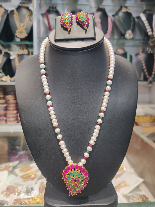 Single line pearls set with rubys emrald locket set