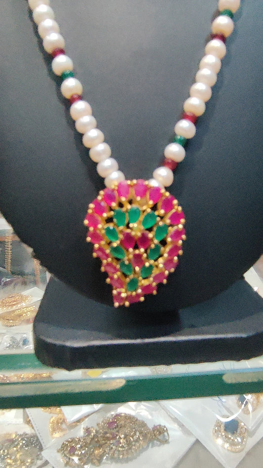 Single line pearls set with rubys emrald locket set